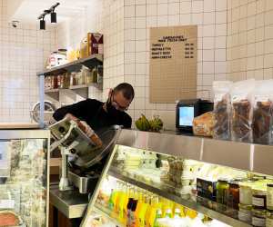 A staff member slices meat inside Russell's Butcher & Deli
